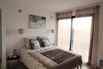 a bedroom with a bed with pillows and a window at Les Bastidons de l'Isle - Le Seguret - 3 étoiles in LʼIsle-sur-la-Sorgue