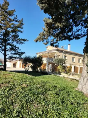 a large building with trees in front of it at Domaines des confines in Monteux