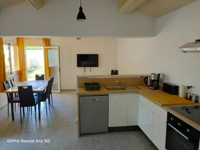 a kitchen with a table and a dining room at Domaines des confines in Monteux