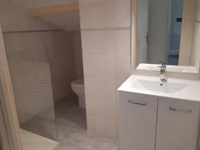 a white bathroom with a sink and a toilet at Domaines des confines in Monteux