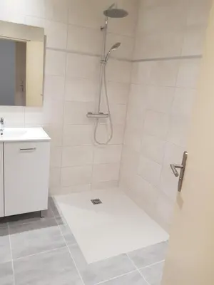a white bathroom with a shower and a sink at Domaines des confines in Monteux