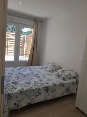 a bedroom with a bed and a window at Domaines des confines in Monteux