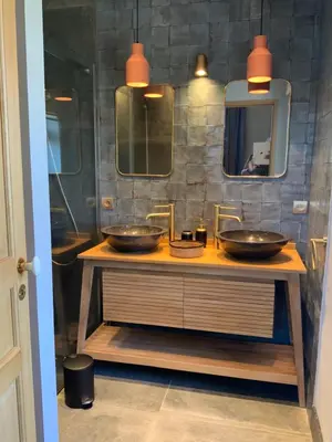 a bathroom with two sinks and a mirror at La Bastide des Grands Chênes in Lambesc