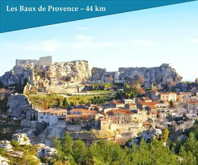 a town on a mountain with a castle on top at Les Bastidons de l'Isle - Le Saumane - 3 étoiles in LʼIsle-sur-la-Sorgue