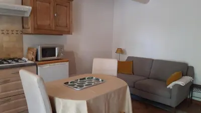 a small living room with a table and a couch at Mini gite foulon in Crillon-le-Brave