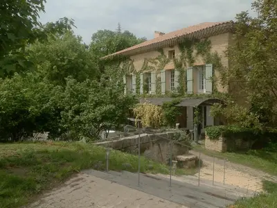 an old house with a fence in front of it at Mini gite foulon in Crillon-le-Brave