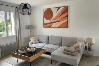 a living room with a couch and a table at Villa Lisa - piscine chauffée in LʼIsle-sur-la-Sorgue