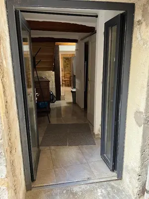 a bedroom with a bed with a black comforter at APPARTEMENT CAROMB proche Mont VENTOUX avec clim in Caromb