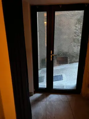 an open door to a hallway with a tile floor at APPARTEMENT CAROMB proche Mont VENTOUX avec clim in Caromb