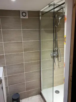 a bathroom with a shower with a glass door at APPARTEMENT CAROMB proche Mont VENTOUX avec clim in Caromb