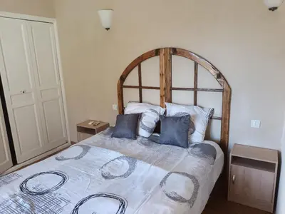 a bedroom with a large bed with blue pillows at Chambres tomate, dans maison avec petit escalier à 6km du festival de piano de la roque d'anthéron in Rognes