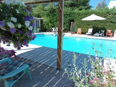 a swimming pool in a yard with chairs and an umbrella at Chambres tomate, dans maison avec petit escalier à 6km du festival de piano de la roque d'anthéron in Rognes