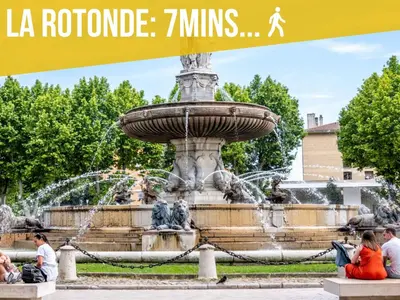 people sitting around a fountain in a park at Lou Pitchoun in Aix-en-Provence