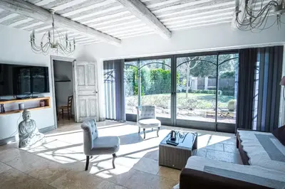 a living room with a couch and chairs at Gîte tout confort - jardin et piscine in Lagnes