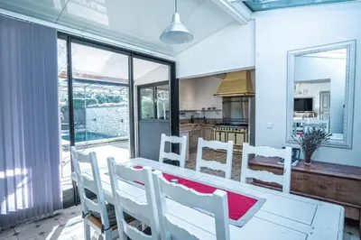 a kitchen and dining room with a table and chairs at Gîte tout confort - jardin et piscine in Lagnes