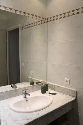 a bathroom with a sink and a large mirror at Bastidon avec piscine Gordes Lubéron in Gordes