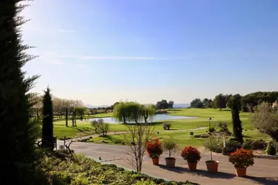 a view of a park with a lake in the background at Apartement Beata in Provence, Golf Pont Royal in Mallemort