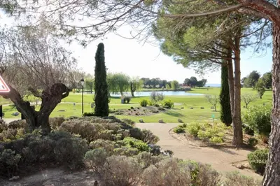a park with a path and trees and a lake at Apartement Beata in Provence, Golf Pont Royal in Mallemort