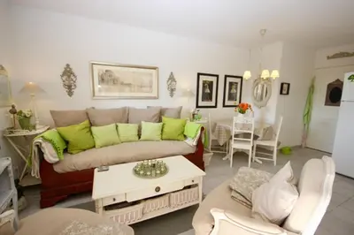 a living room with a couch and a table at Apartement Beata in Provence, Golf Pont Royal in Mallemort