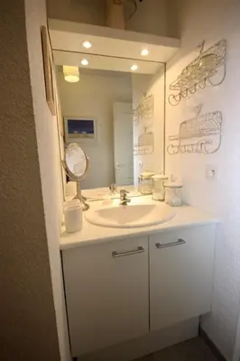 a bathroom with a white sink and a mirror at Apartement Beata in Provence, Golf Pont Royal in Mallemort