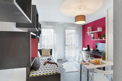 a living room with a couch and a table at Résidence Nemea Aix Campus 2 in Aix-en-Provence