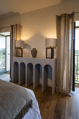 a bedroom with a bed and two lamps on a table at Le Mas Luca in Gordes