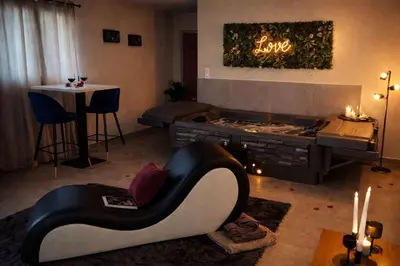 a living room with a couch and a fireplace at Eden House, Cocon sensuel et romantique avec jacuzzi in Carpentras