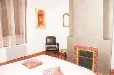 a bedroom with a bed and a fireplace at Appartement de Charme in Aix-en-Provence