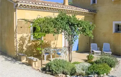 a patio with a table and chairs next to a building at Gorgeous Home In Roussillon With Wifi in Roussillon