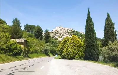 an empty road with a building on the hill at Gorgeous Home In Roussillon With Wifi in Roussillon