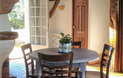 a dining room with a table and chairs with a plant on it at Gorgeous Home In Roussillon With Wifi in Roussillon