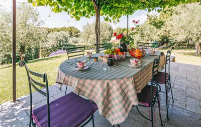 a table with a bowl of fruit on it at Gorgeous Home In Lioux With Wifi in Lioux
