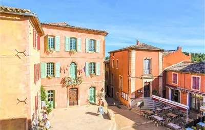 a group of buildings with tables and chairs in a street at Gorgeous Home In Lioux With Wifi in Lioux