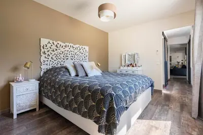 a bedroom with a bed with a blue and white bedspread at Maison de Charme en Provence avec jardin et piscine in Carpentras