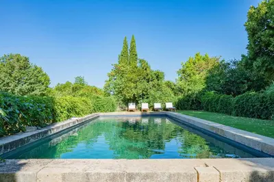 a swimming pool in the middle of a garden at Prieuré Notre-Dame de Conil - 12e siècle in Rognes