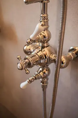 a close up of a brass water faucet at Prieuré Notre-Dame de Conil - 12e siècle in Rognes