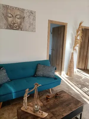 a living room with a blue couch and a table at Cocoon inn&Spa in Saint-Saturnin-les-Avignon
