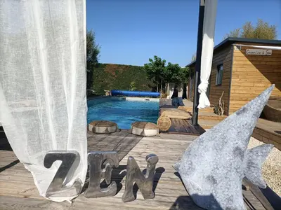 a swimming pool with a sign that says zodiac at Cocoon inn&Spa in Saint-Saturnin-les-Avignon