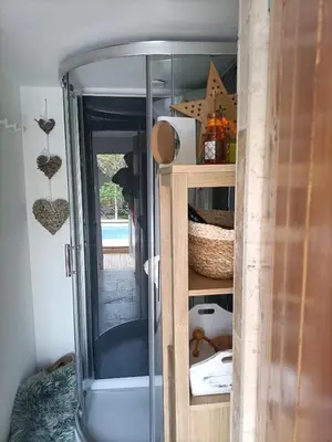 a glass cabinet with a glass door in a room at Cocoon inn&Spa in Saint-Saturnin-les-Avignon