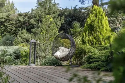 a swing sitting on top of a wooden deck at Provence mon amour in La Tour-dʼAigues
