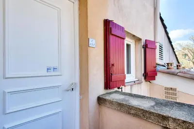 an open door with red shutters and a window at Village Pont Royal en Provence - maeva Home - Appartement 2 Pièces 5 Personnes - Sélection - super Home MAE-1242 in Mallemort