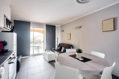 a kitchen and living room with a table and chairs at Village Pont Royal en Provence - maeva Home - Appartement 2 Pièces 5 Personnes - Sélection - super Home MAE-1242 in Mallemort
