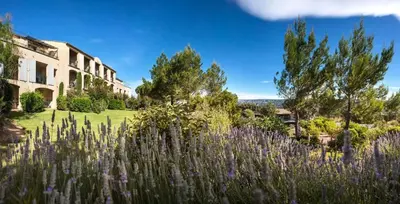 a garden with purple flowers in front of a building at Village Pont Royal en Provence - maeva Home - Appartement 2 Pièces 5 Personnes - Sélection - super Home MAE-1242 in Mallemort