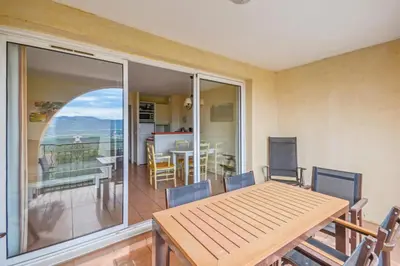 a dining room with a table and a balcony at Village Pont Royal en Provence - maeva Home - Appartement 2 pièces 6 personnes Sélection MAE-7984 in Mallemort