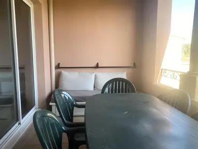 a table and chairs in a room with a window at Village Pont Royal en Provence - maeva Home - Appartement 2 pièces 6 personnes climatisé - Prestige MAE-4537 in Mallemort