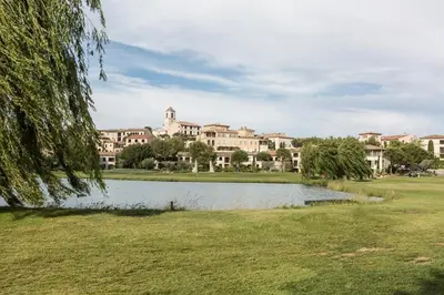a park with a lake in front of a building at Village Pont Royal en Provence - maeva Home - Appartement climatisé avec terrasse 4 pièces 8 personnes - Prestige - super Home MAE-6210 in Mallemort