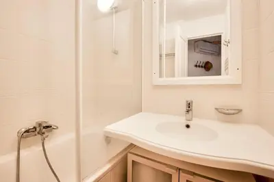 a white bathroom with a sink and a shower at Village Pont Royal en Provence - maeva Home - Appartement climatisé avec terrasse 4 pièces 8 personnes - Prestige - super Home MAE-6210 in Mallemort