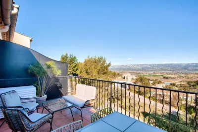 a balcony with two chairs and a table at Village Pont Royal en Provence - maeva Home - Appartement climatisé avec terrasse 4 pièces 8 personnes - Prestige - super Home MAE-6210 in Mallemort