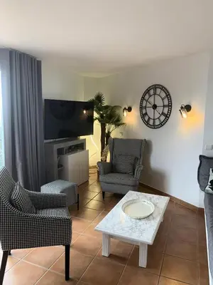 a living room with two chairs and a table at Village Pont Royal en Provence - maeva Home - Appartement climatisé avec terrasse 4 pièces 8 personnes - Prestige - super Home MAE-6210 in Mallemort