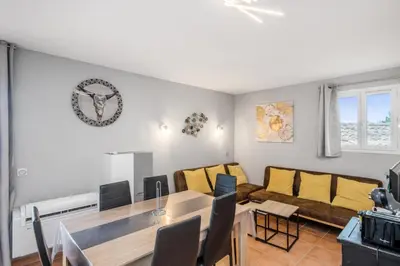 a living room with a table and a couch at Village Pont Royal en Provence - maeva Home - Appartement moderne climatisé 4 pièces 8 personnes - Sélection - super Home MAE-8568 in Mallemort